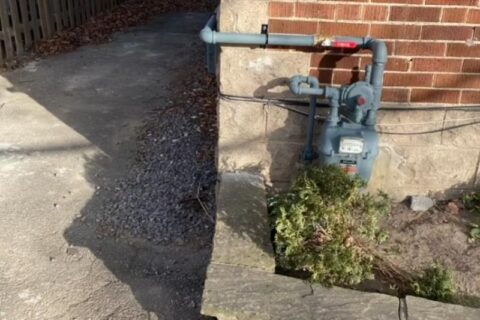 Outdoor gas meter with connected pipes