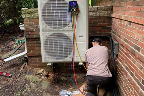A technician working on an air conditioner