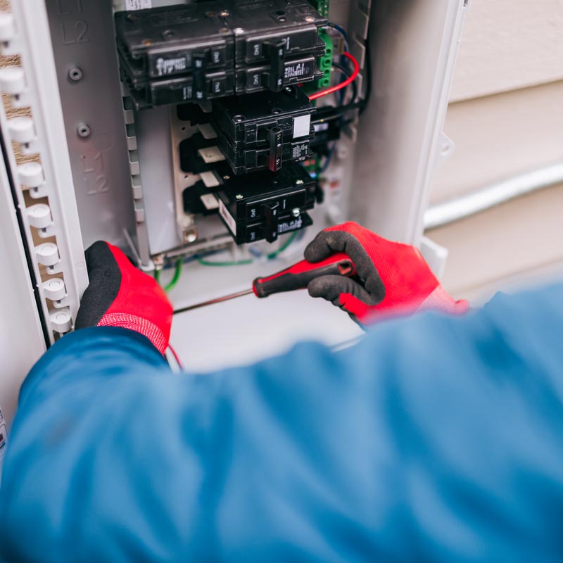 electrician installing electrical panel
