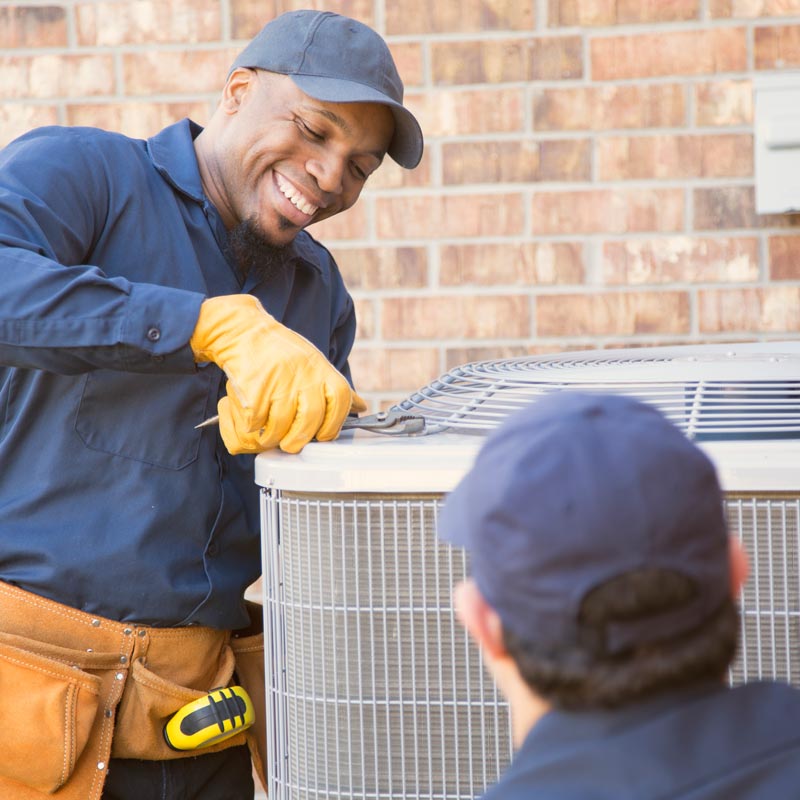 two technicians repairing air conditioner