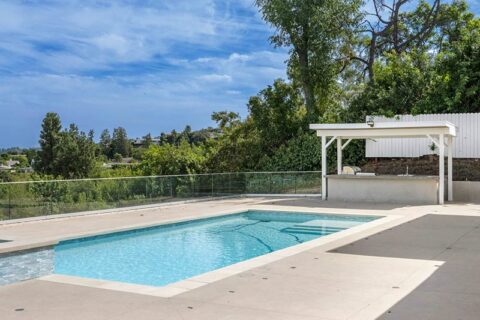 exterior view of a house with a welcoming pool