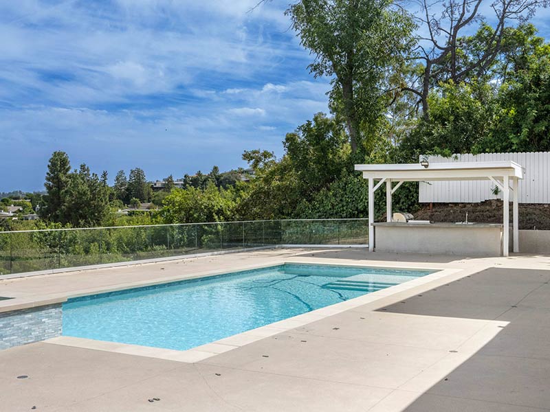 exterior view of a house with a welcoming pool exterior view of a house with a welcoming pool
