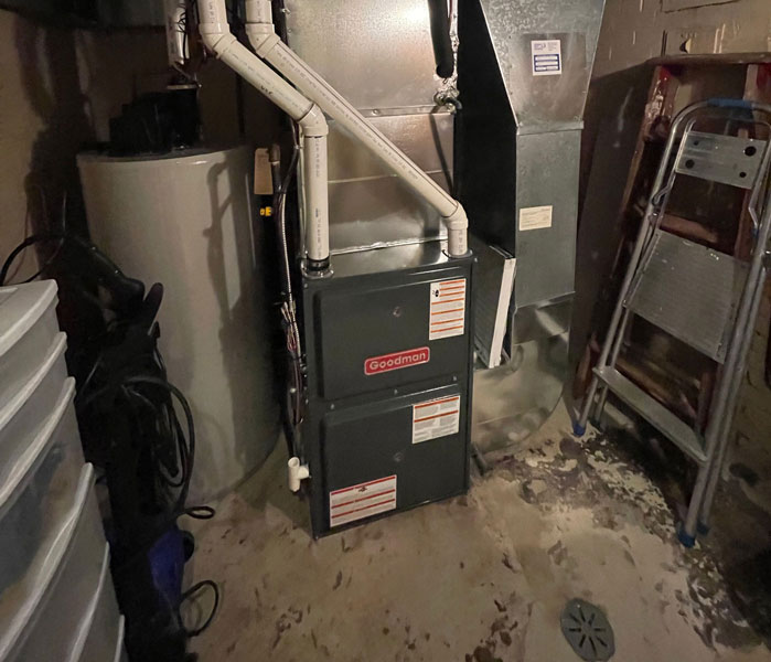 Basement with Goodman furnace, water heater, and PVC pipes Basement with Goodman furnace, water heater, and PVC pipes