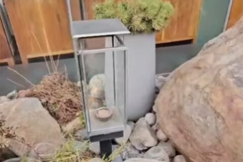 Outdoor garden scene featuring a glass lantern