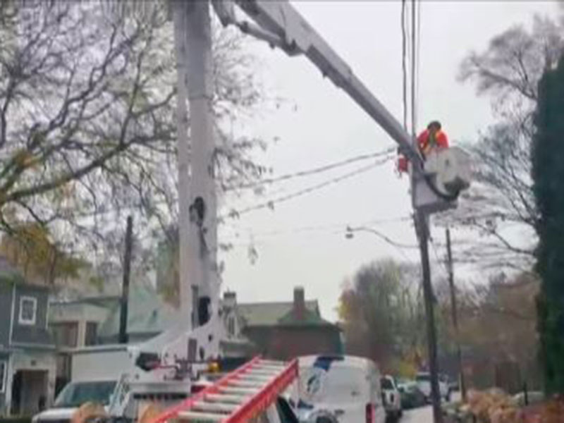 A bucket truck on the road fixing wires