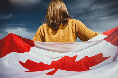 A women holding the Canadian flag