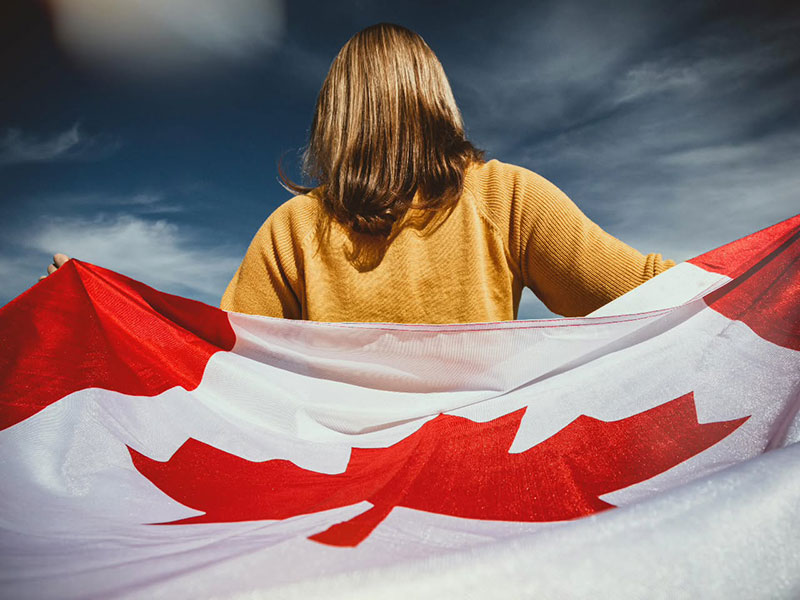 A women holding the Canadian flag