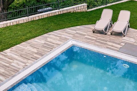 two sun loungers next to pool